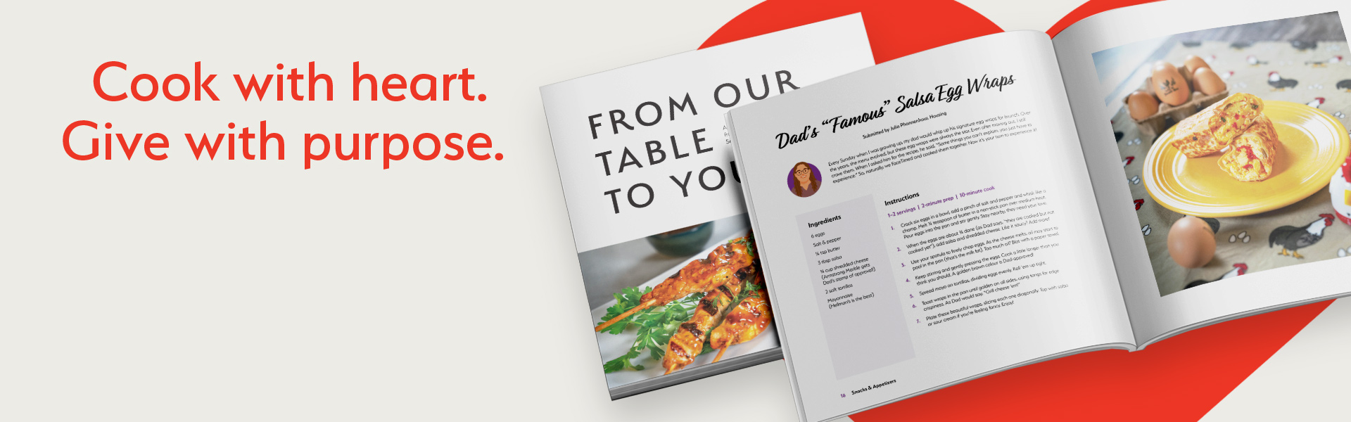 A cook book on top of a red heart.