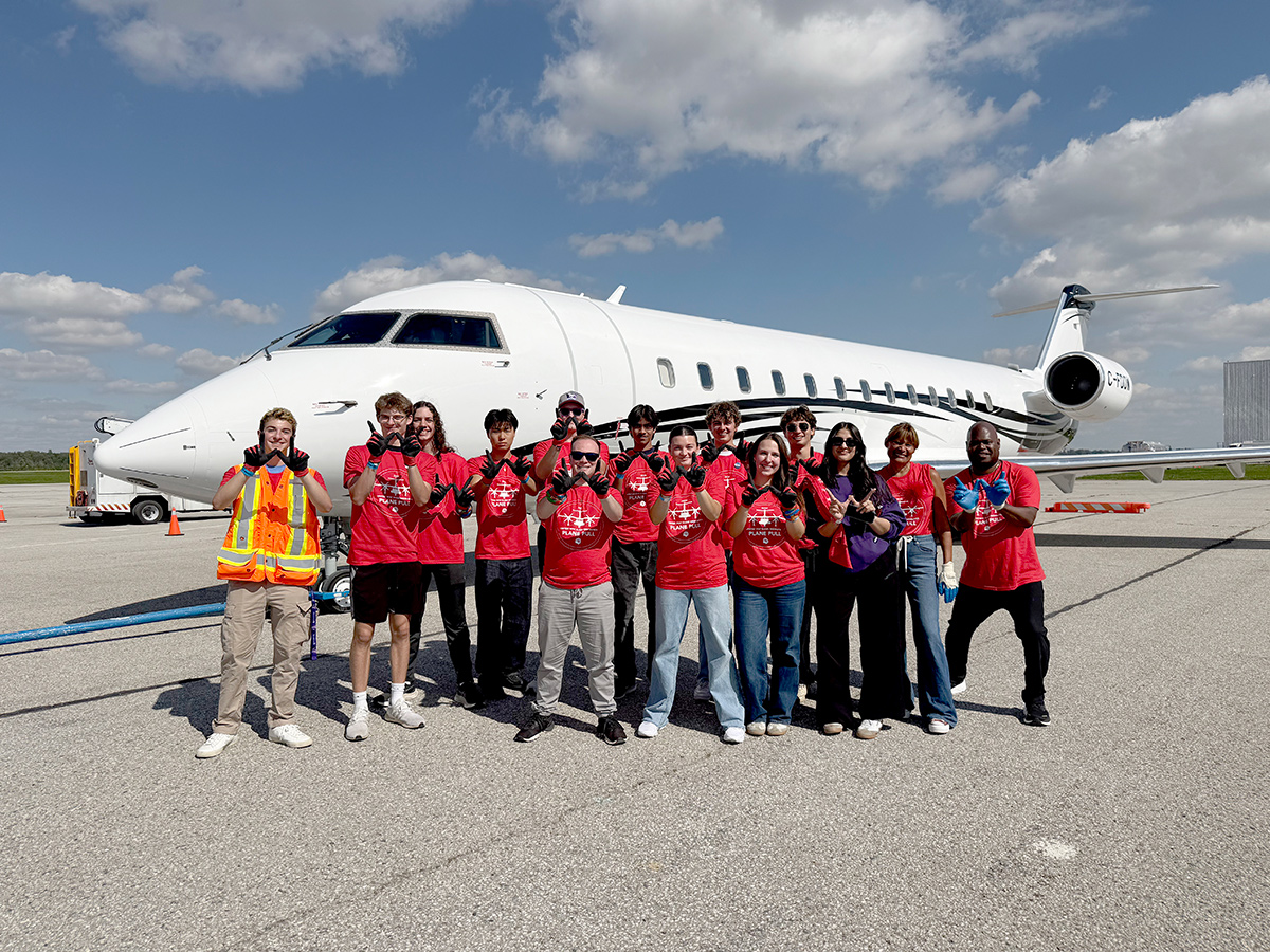 Western students in front of a private jet.