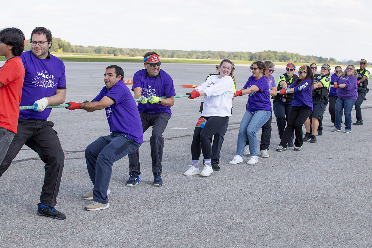 Team members pull a giant Air Canada plane.