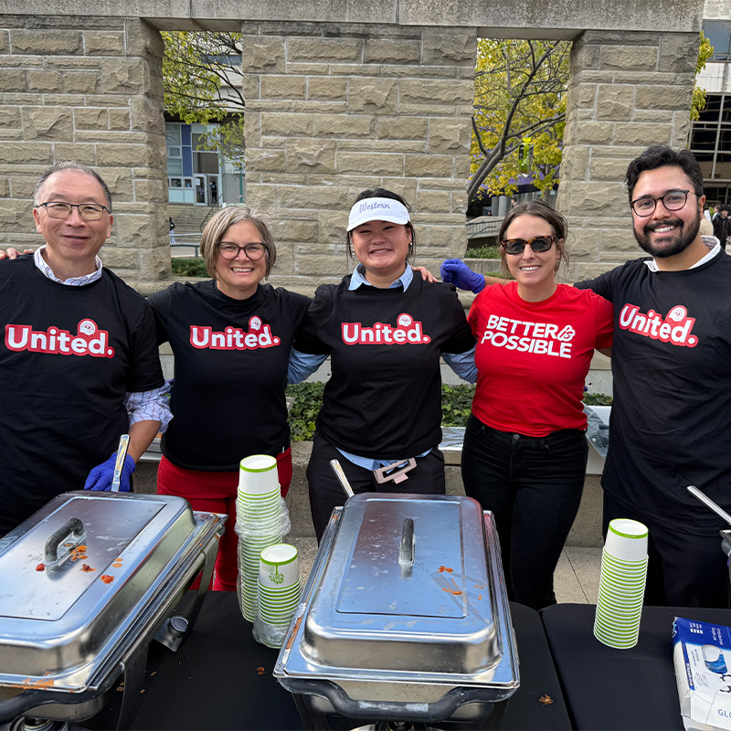 Staff volunteers pose for a photo at the chili kickoff event